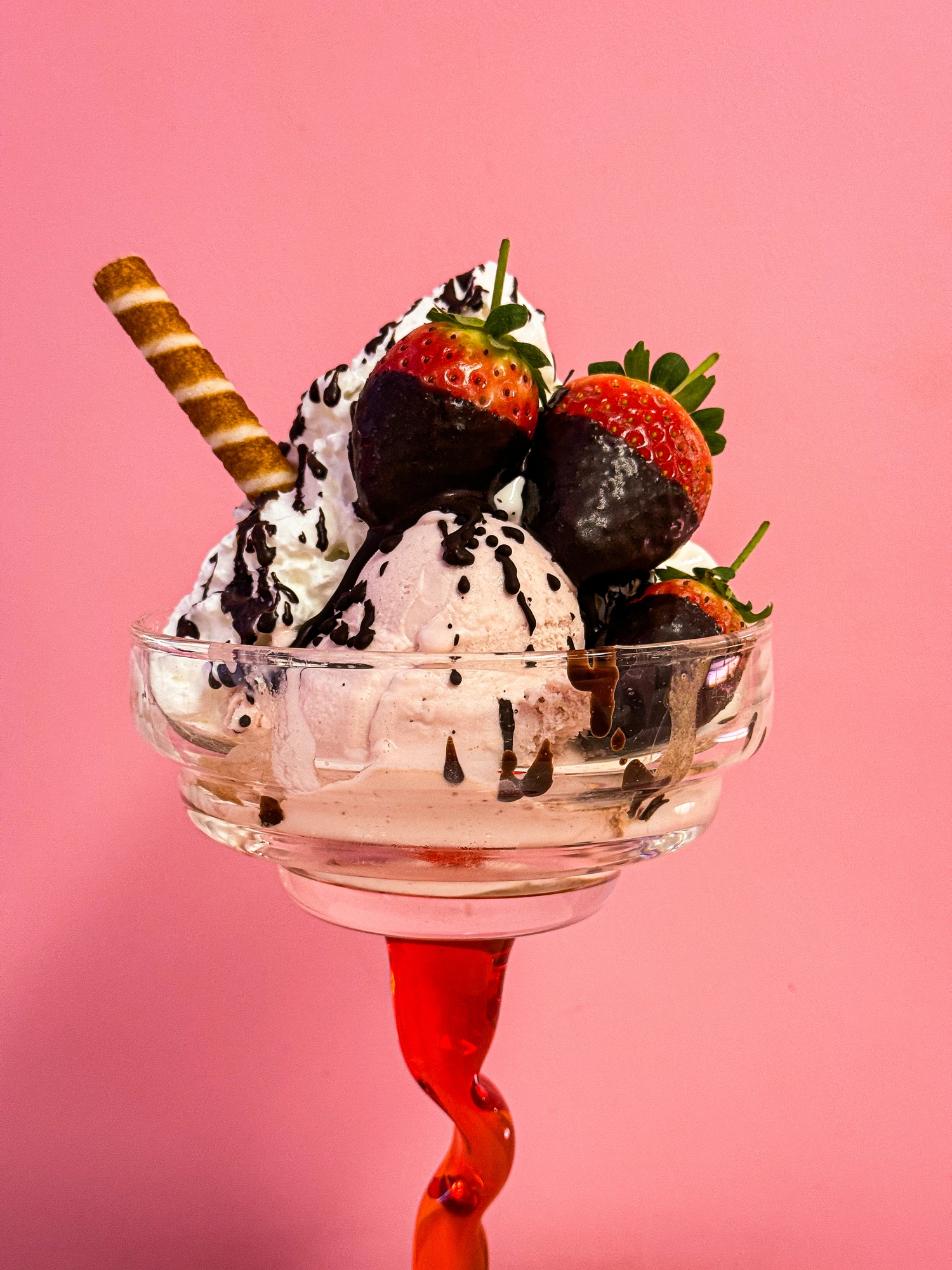 A Morelli's strawberry sundae with whipped cream and a wafer